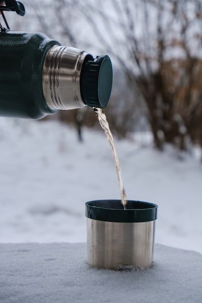 Image of a flask pouring a warm drink